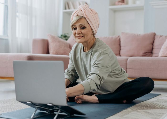 Clean and open room with a yoga mat, ready for a workout session.