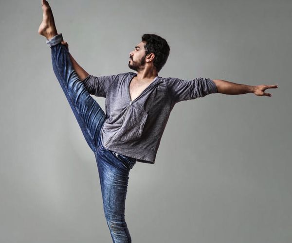 Man in a controlled athletic pose, symbolizing balance and strength.